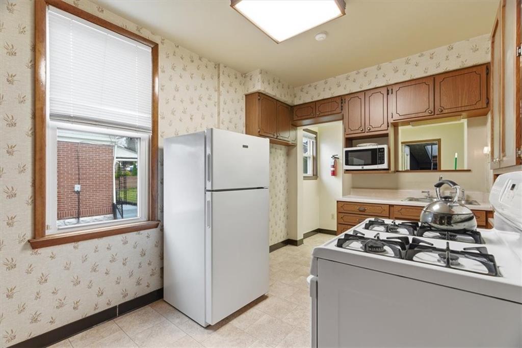2375 East Beckert Avenue Pittsburgh, PA 15212 - Photo 12 of 28 a kitchen with stainless steel appliances granite countertop a refrigerator stove and sink