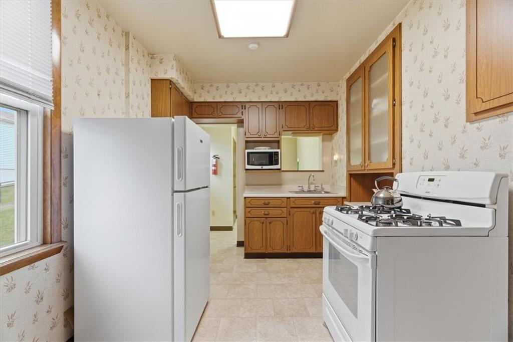 2375 East Beckert Avenue Pittsburgh, PA 15212 - Photo 13 of 28 a kitchen with stainless steel appliances granite countertop a refrigerator sink and stove