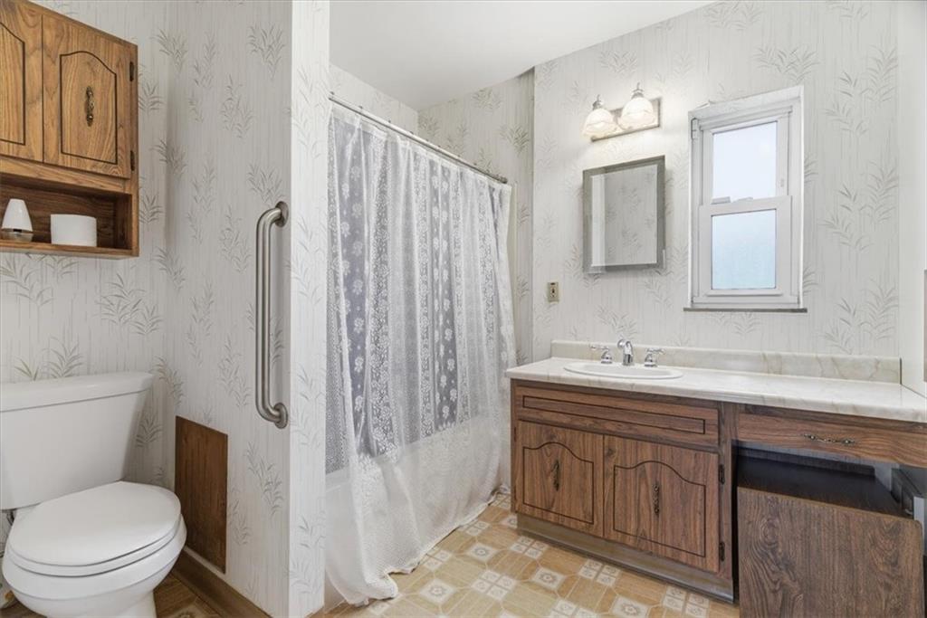 2375 East Beckert Avenue Pittsburgh, PA 15212 - Photo 19 of 28 a bathroom with a toilet a sink a mirror a bathtub and shower