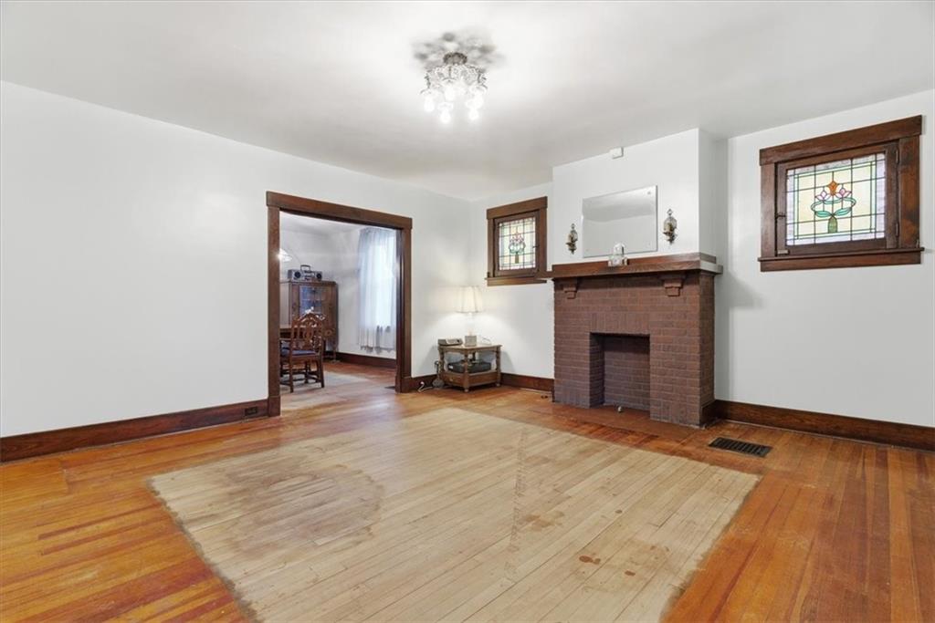 2375 East Beckert Avenue Pittsburgh, PA 15212 - Photo 6 of 28 wooden floor fireplace and windows in an empty room