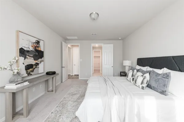 a bedroom with a bed and a large mirror