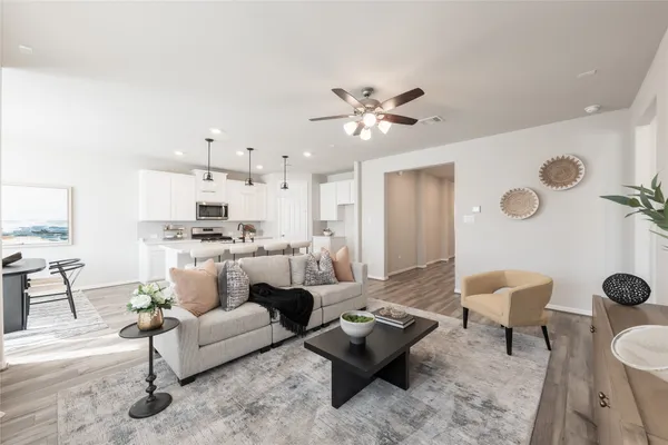 a living room with furniture kitchen view and a table