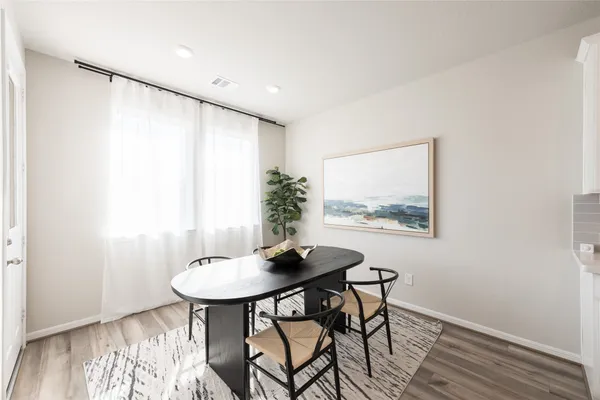 a view of a very nice looking dining room with a table and chairs