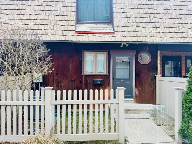 a view of entrance of a house with deck and furniture