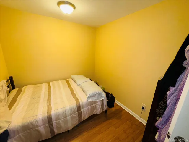 a bed sitting in a bedroom next to a blue wall