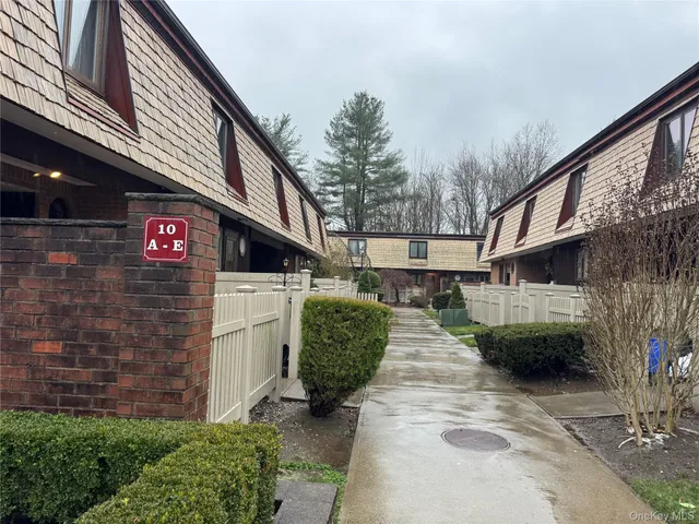 a view of a street with brick walls