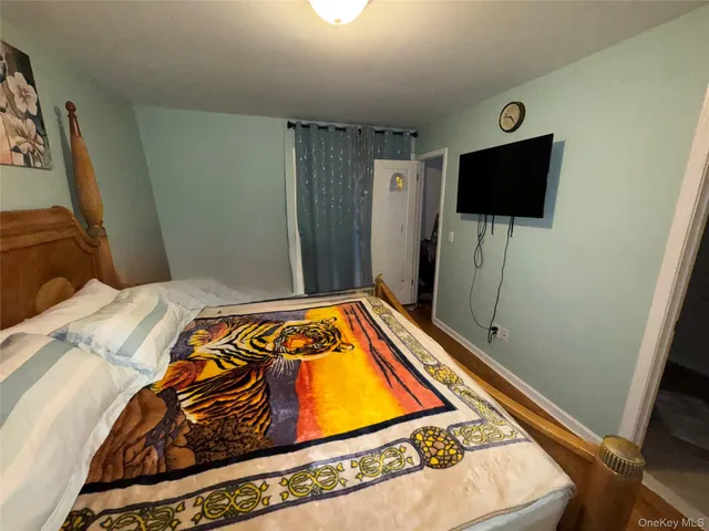 a bedroom with a bed and flat screen tv