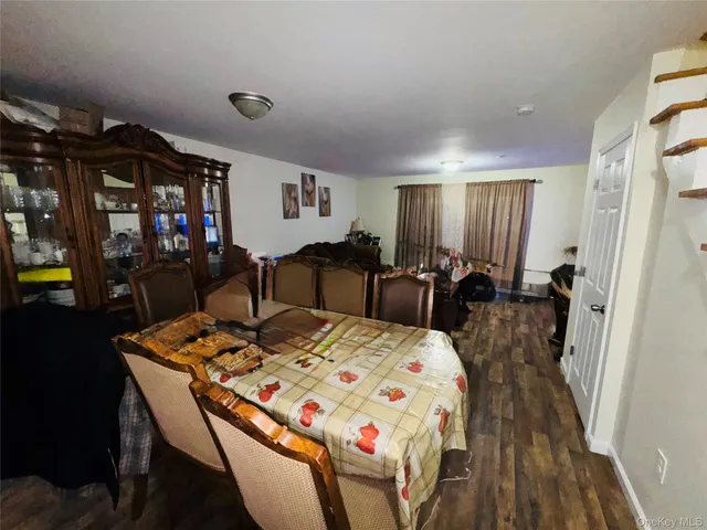 a large dining space with furniture and wooden floor