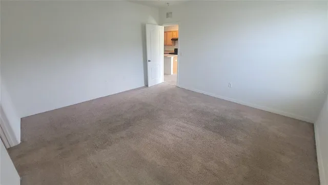 an empty room with wooden floor and a window