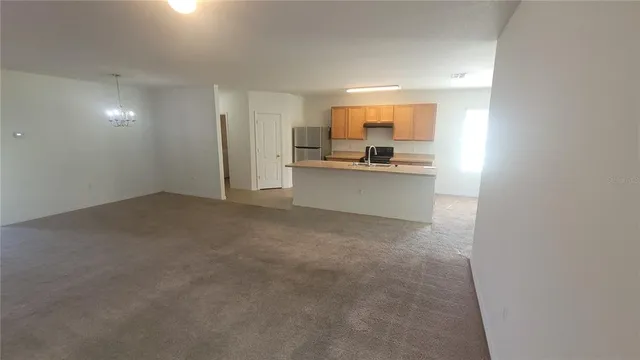 a view of a kitchen with a sink and cabinets