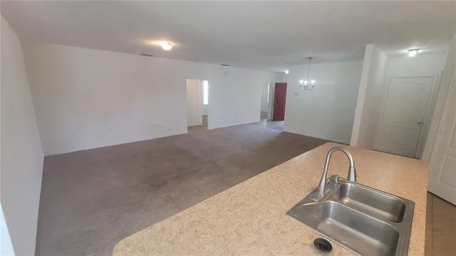 a view of a sink and a refrigerator
