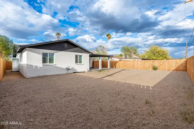 a view of house with backyard and garden