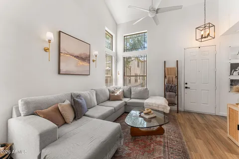 a living room with furniture and wooden floor