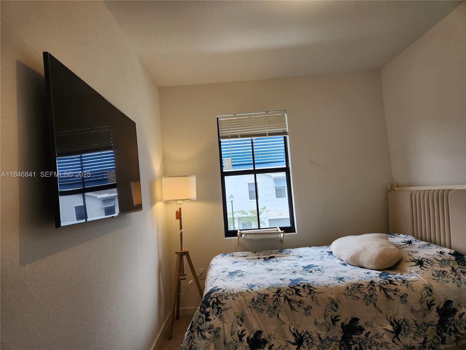 880 Northwest 3rd Way, Unit 880 Pompano Beach, FL 33060 - Photo 13 of 34 a bedroom with a bed and a window