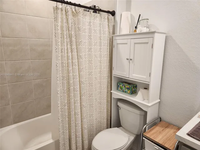 a white toilet sitting next to a bathroom sink