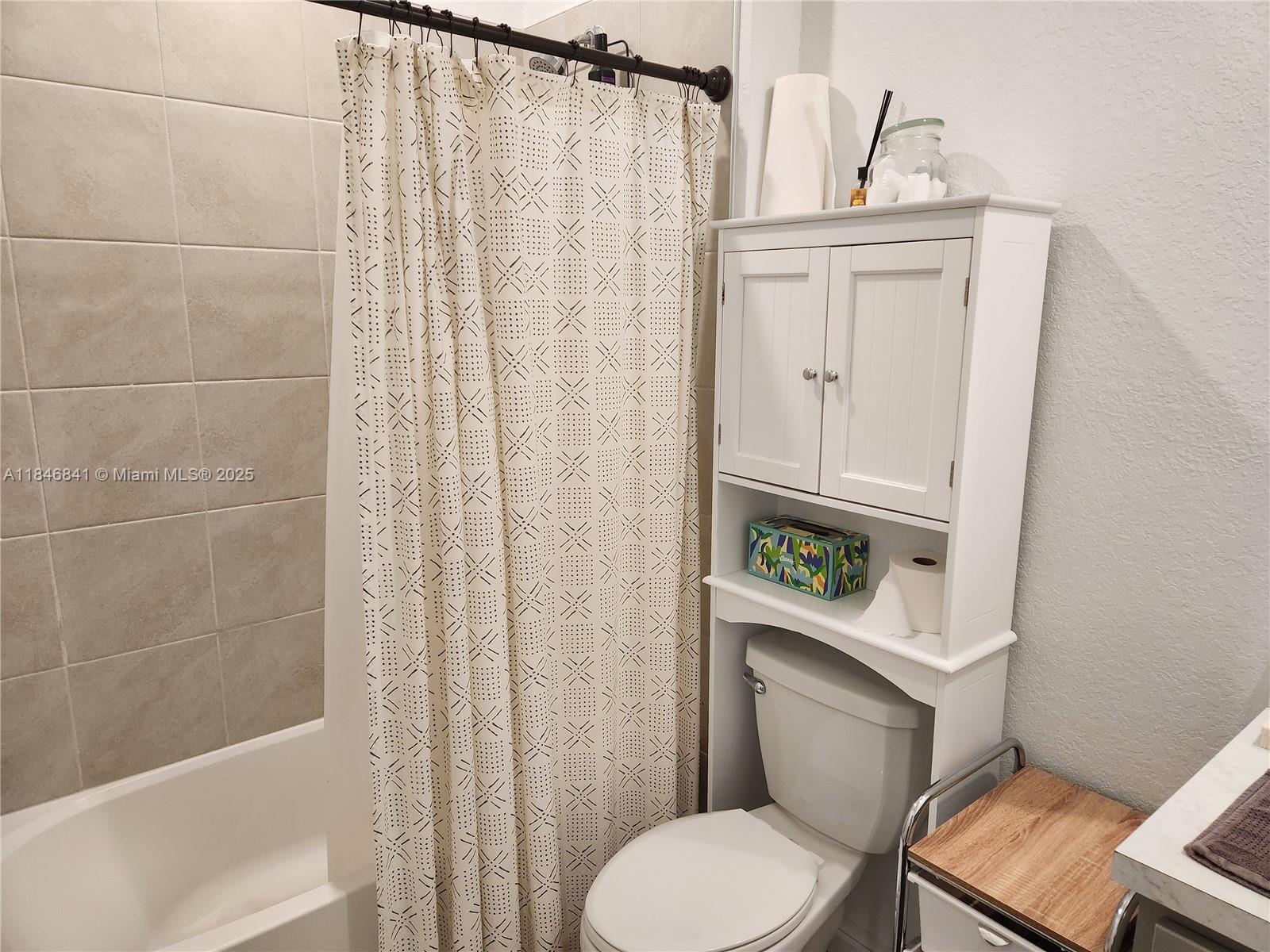 880 Northwest 3rd Way, Unit 880 Pompano Beach, FL 33060 - Photo 20 of 34 a white toilet sitting next to a bathroom sink