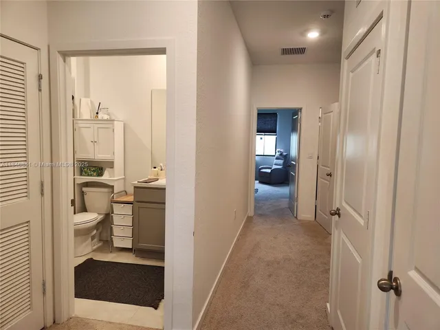a view of a hallway with living room and dining room view