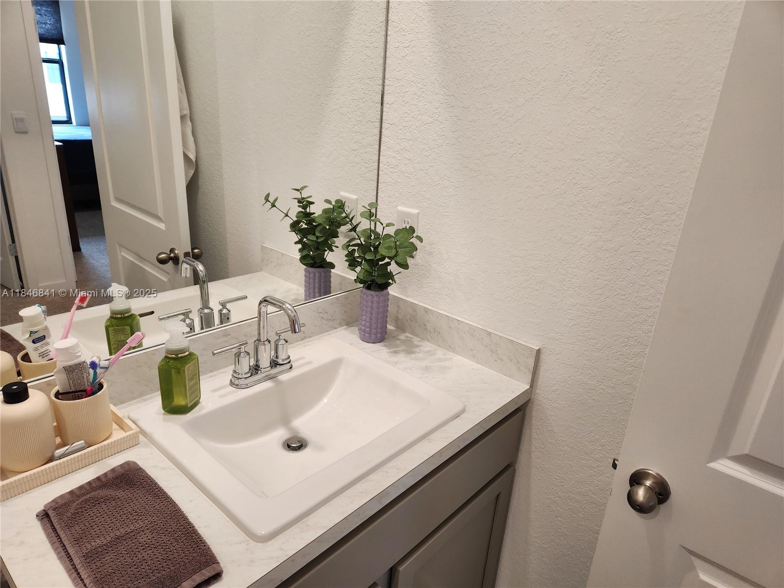 880 Northwest 3rd Way, Unit 880 Pompano Beach, FL 33060 - Photo 22 of 34 a bathroom with a sink and a mirror
