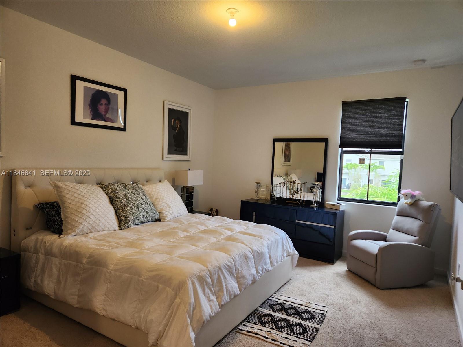 880 Northwest 3rd Way, Unit 880 Pompano Beach, FL 33060 - Photo 23 of 34 a bedroom with a bed and a couch