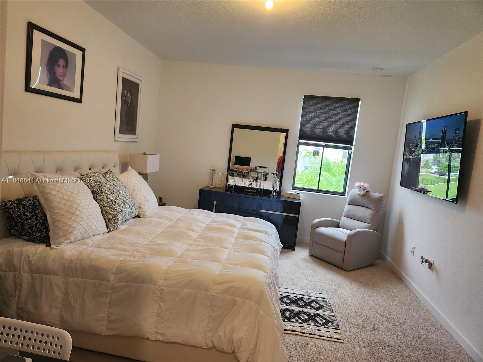 880 Northwest 3rd Way, Unit 880 Pompano Beach, FL 33060 - Photo 24 of 34 a bedroom with a balcony a bed and a couch