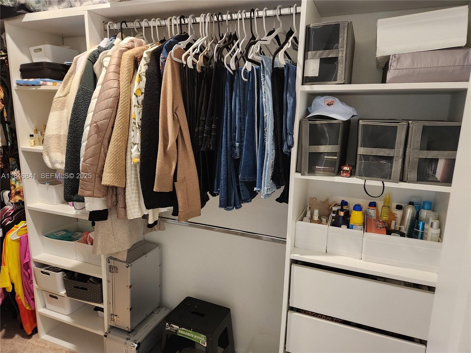 880 Northwest 3rd Way, Unit 880 Pompano Beach, FL 33060 - Photo 26 of 34 a view of walk in closet with clothes and shoes
