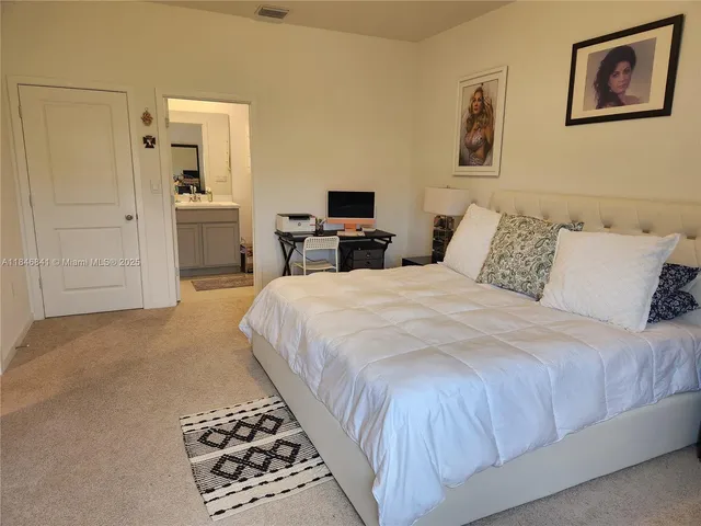 a bedroom with a bed and a view of bathroom