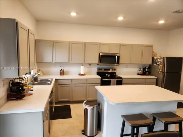 a kitchen with refrigerator and stove