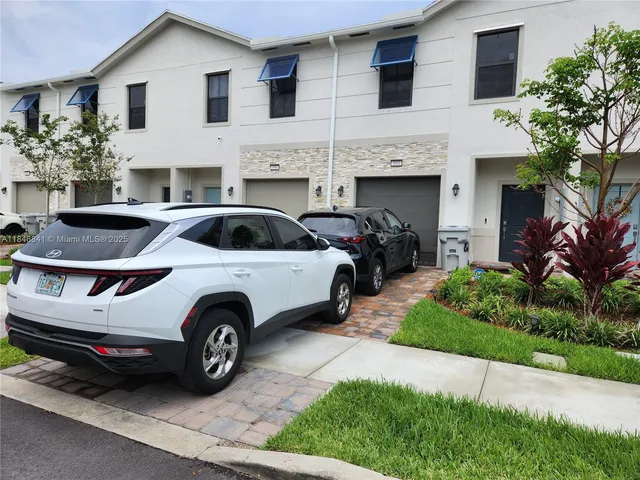 a view of a car parked in front of a house