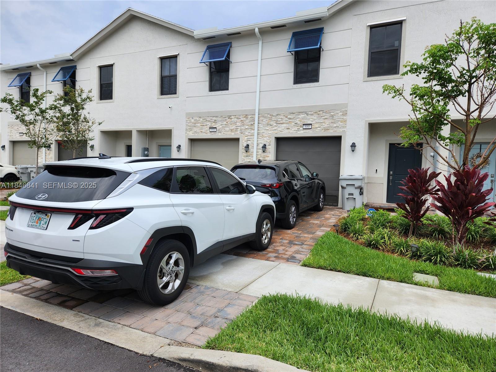 880 Northwest 3rd Way, Unit 880 Pompano Beach, FL 33060 - Photo 33 of 34 a view of a car parked in front of a house