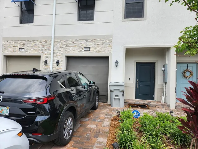 a front view of a house with parking space