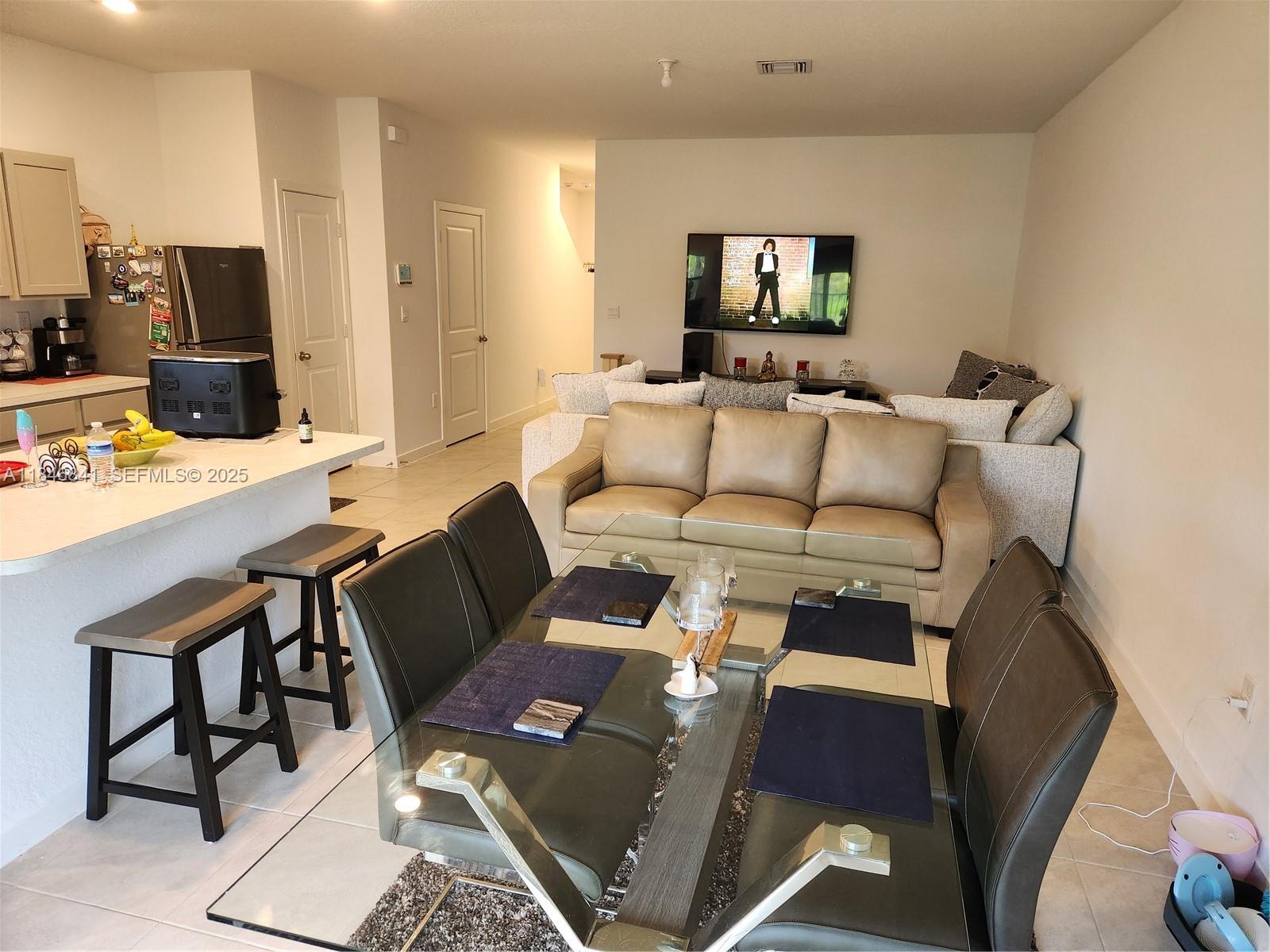 880 Northwest 3rd Way, Unit 880 Pompano Beach, FL 33060 - Photo 8 of 34 a living room with furniture and a flat screen tv