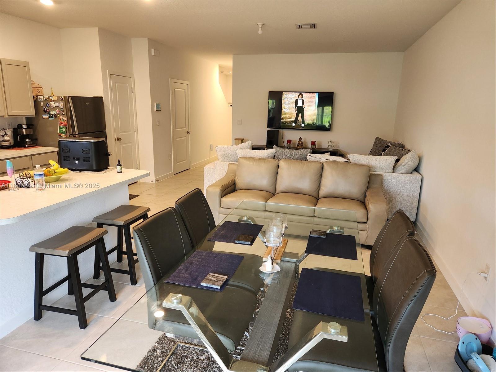 880 Northwest 3rd Way, Unit 880 Pompano Beach, FL 33060 - Photo 8 of 34 a living room with furniture and a flat screen tv