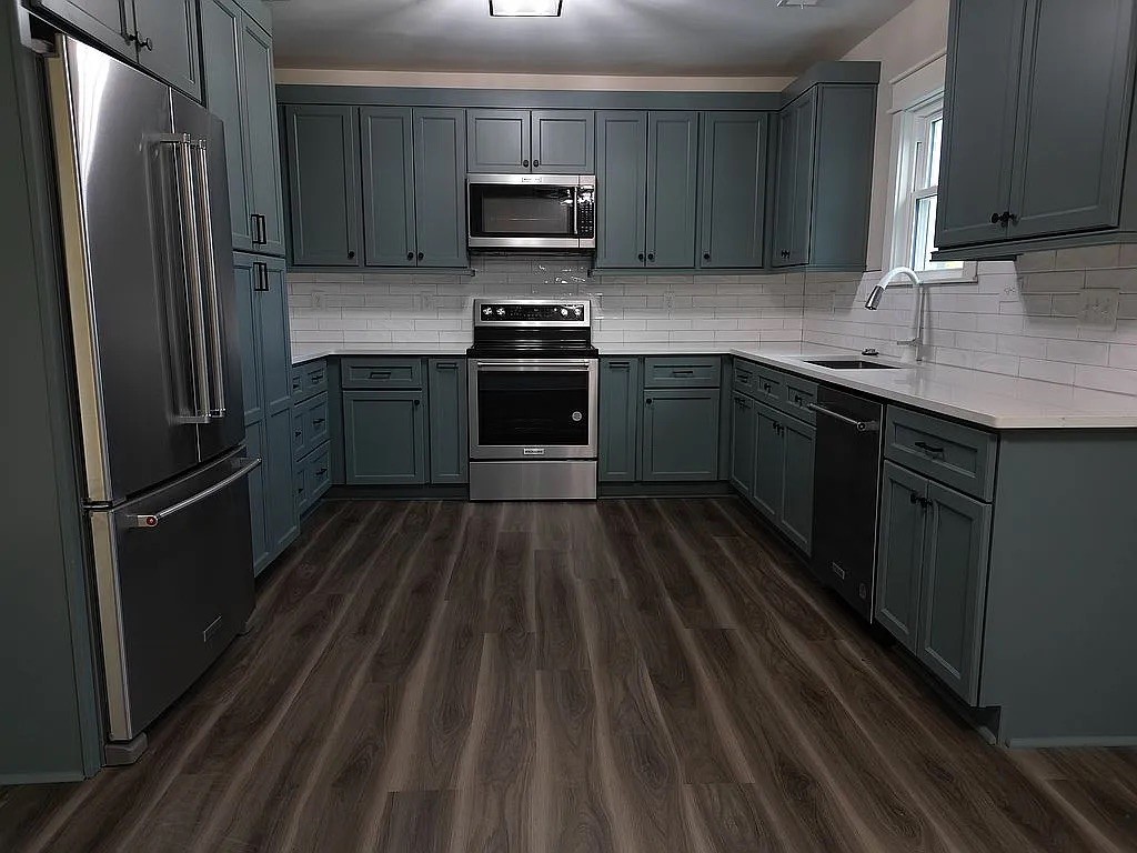 7140 Carthage Road Pleasant Shade, TN 37145 - Photo 11 of 36 a kitchen with a refrigerator stove and sink