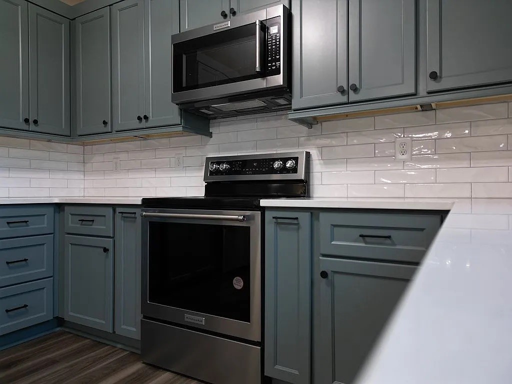 7140 Carthage Road Pleasant Shade, TN 37145 - Photo 12 of 36 a kitchen with stainless steel appliances granite countertop a stove microwave and oven