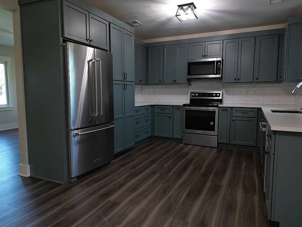 7140 Carthage Road Pleasant Shade, TN 37145 - Photo 14 of 36 a kitchen with stainless steel appliances a refrigerator stove and microwave