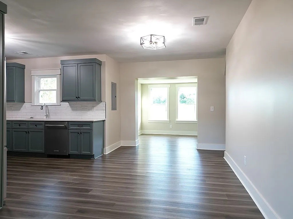 7140 Carthage Road Pleasant Shade, TN 37145 - Photo 15 of 36 a large kitchen with stainless steel appliances granite countertop a sink and a wooden floor