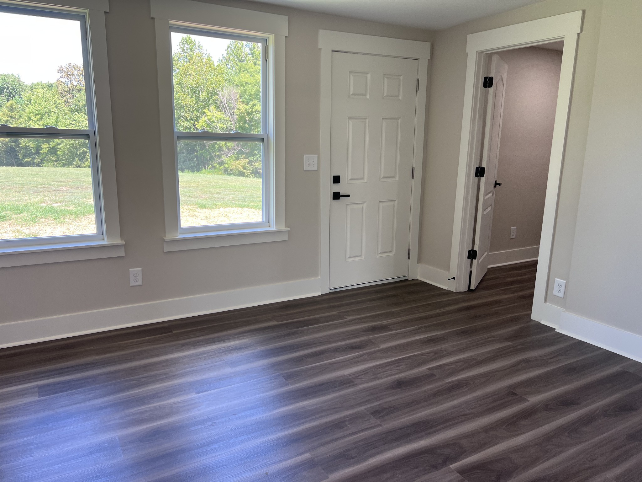 7140 Carthage Road Pleasant Shade, TN 37145 - Photo 18 of 36 an empty room with wooden floor and windows