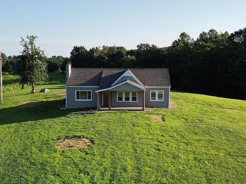 7140 Carthage Road Pleasant Shade, TN 37145 - Photo 2 of 36 a house with green field in front of it