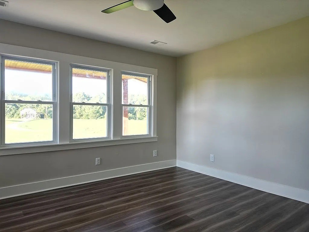 7140 Carthage Road Pleasant Shade, TN 37145 - Photo 26 of 36 an empty room with wooden floor and windows