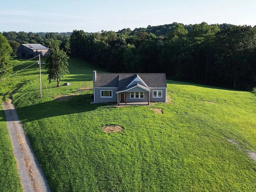 7140 Carthage Road Pleasant Shade, TN 37145 - Photo 3 of 36 a front view of a house with garden