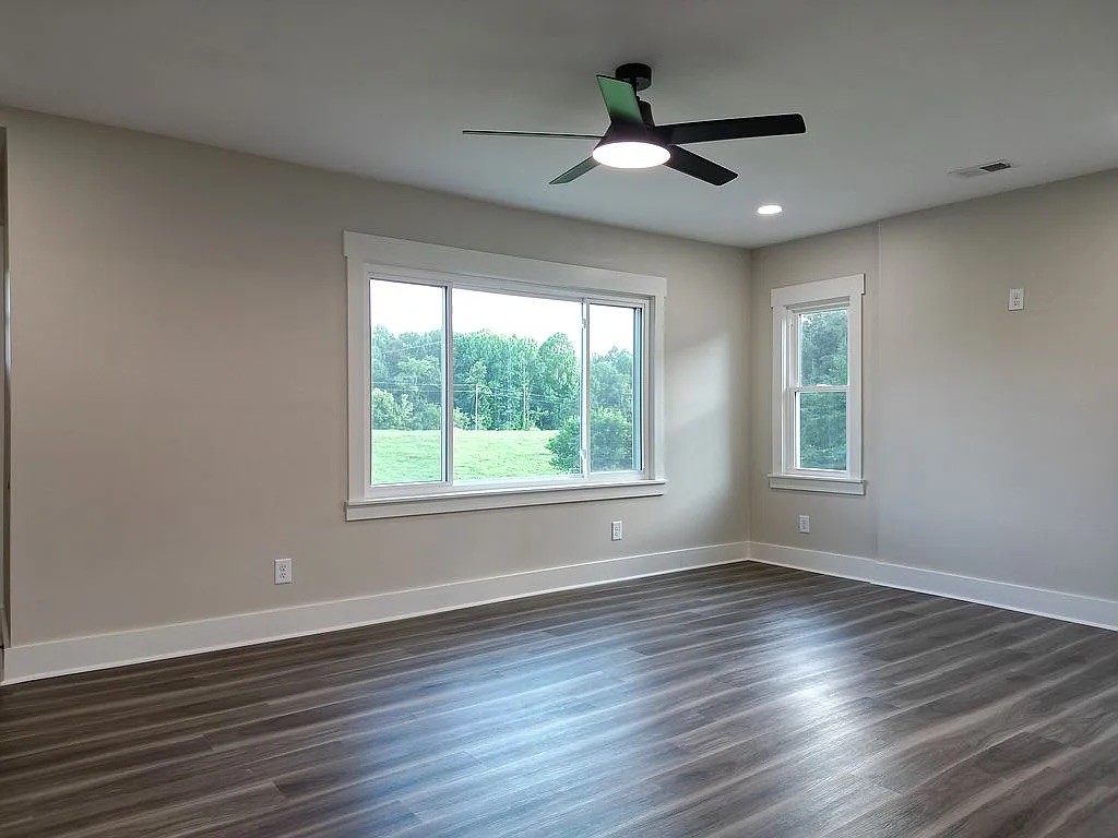 7140 Carthage Road Pleasant Shade, TN 37145 - Photo 9 of 36 a view of an empty room with wooden floor and a window
