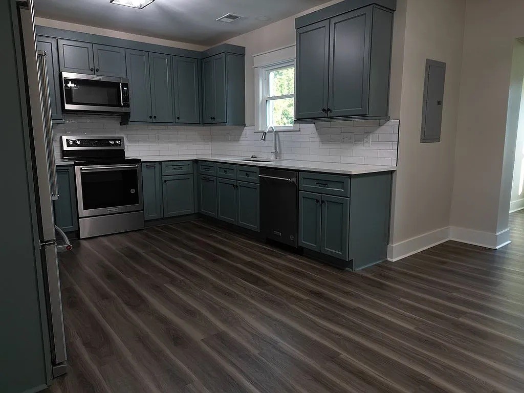 7140 Carthage Road Pleasant Shade, TN 37145 - Photo 10 of 36 a kitchen with stainless steel appliances granite countertop a sink stove and microwave