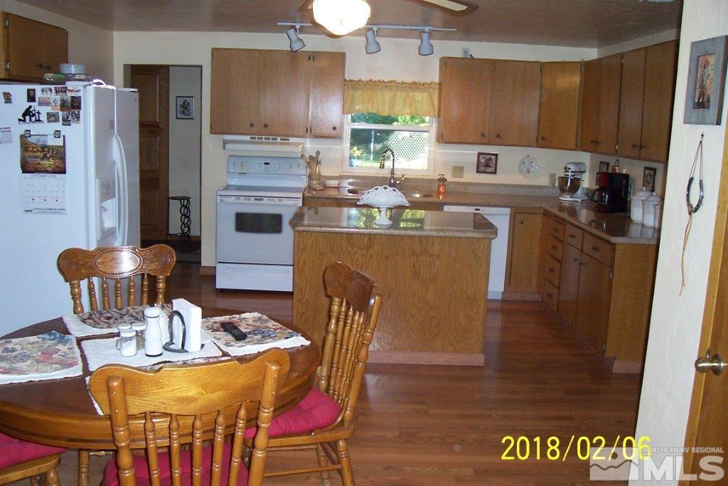 3700 Alcorn Road Fallon, NV 89406 - Photo 6 of 25 a kitchen with stainless steel appliances a dining table chairs and a refrigerator