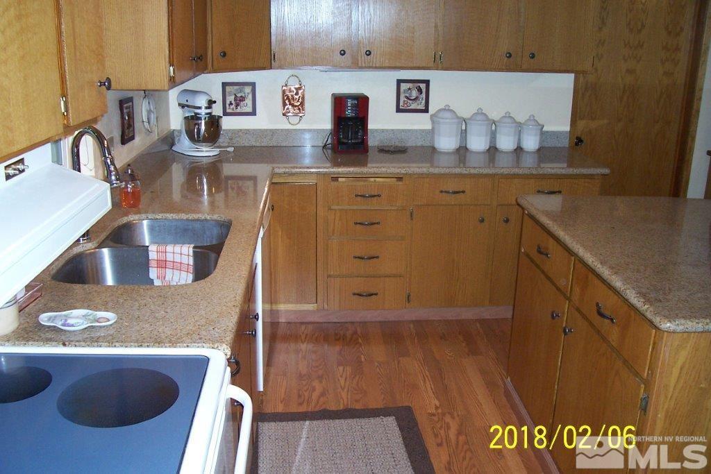 3700 Alcorn Road Fallon, NV 89406 - Photo 7 of 25 a kitchen with kitchen island granite countertop a sink and a stove