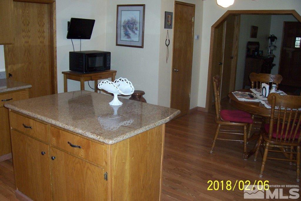3700 Alcorn Road Fallon, NV 89406 - Photo 8 of 25 a kitchen with a table chairs and a refrigerator