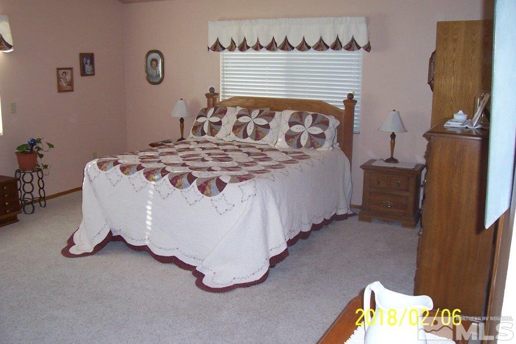 3700 Alcorn Road Fallon, NV 89406 - Photo 10 of 25 a bed sitting in a bedroom next to a window