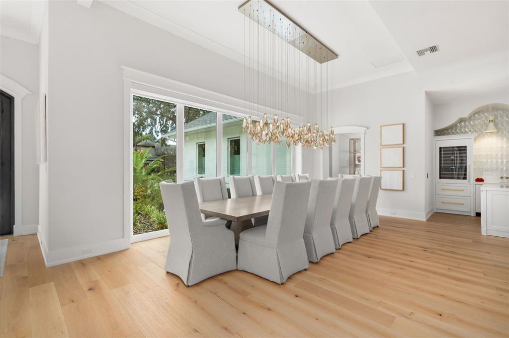 8679 Southwest 28 Lane Gainesville, FL 32608 - Photo 12 of 64 a living room with furniture a large window and wooden floor