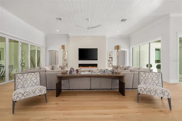 a spacious bedroom with a bed and a flat screen tv