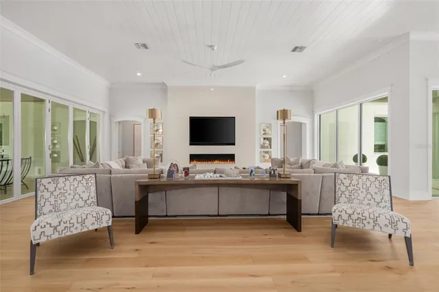 a spacious bedroom with a bed and a flat screen tv