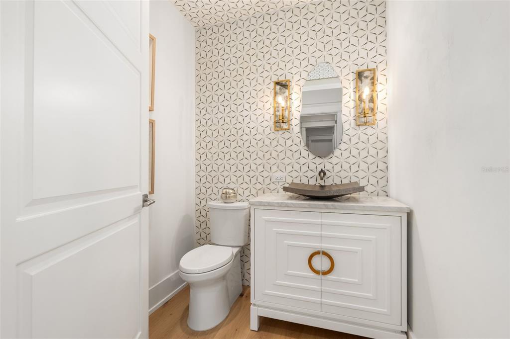 8679 Southwest 28 Lane Gainesville, FL 32608 - Photo 17 of 64 a bathroom with a toilet a sink and mirror